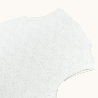 KNITTED BUTTONED WAISTCOAT - CREAM; 100% Organic Cotton; Waistcoat made from GOTS-certified organic cotton; Wooden button at shoulder for easy dressing; Rib finish at neck, hem and cuffs; Relaxed fit.