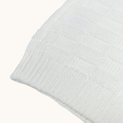 KNITTED BUTTONED WAISTCOAT - CREAM; 100% Organic Cotton; Waistcoat made from GOTS-certified organic cotton; Wooden button at shoulder for easy dressing; Rib finish at neck, hem and cuffs; Relaxed fit.