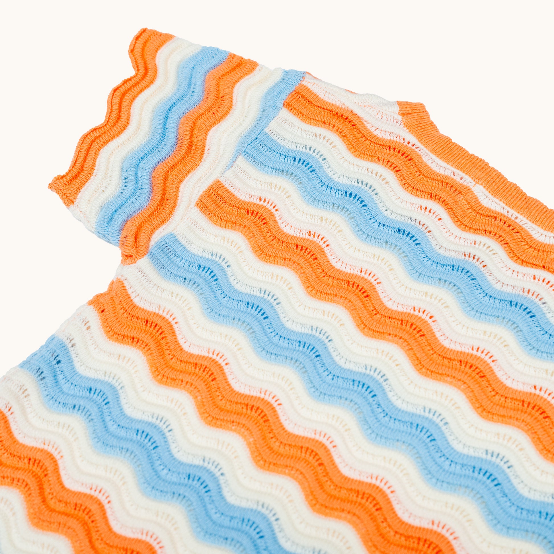 KNITTED WAVY SUMMER DRESS - CORAL; 100% Organic Cotton; Summer Dress made from GOTS-certified organic cotton; Scalloped edge at cuffs; Rib finish at hem; Dropped shoulder.