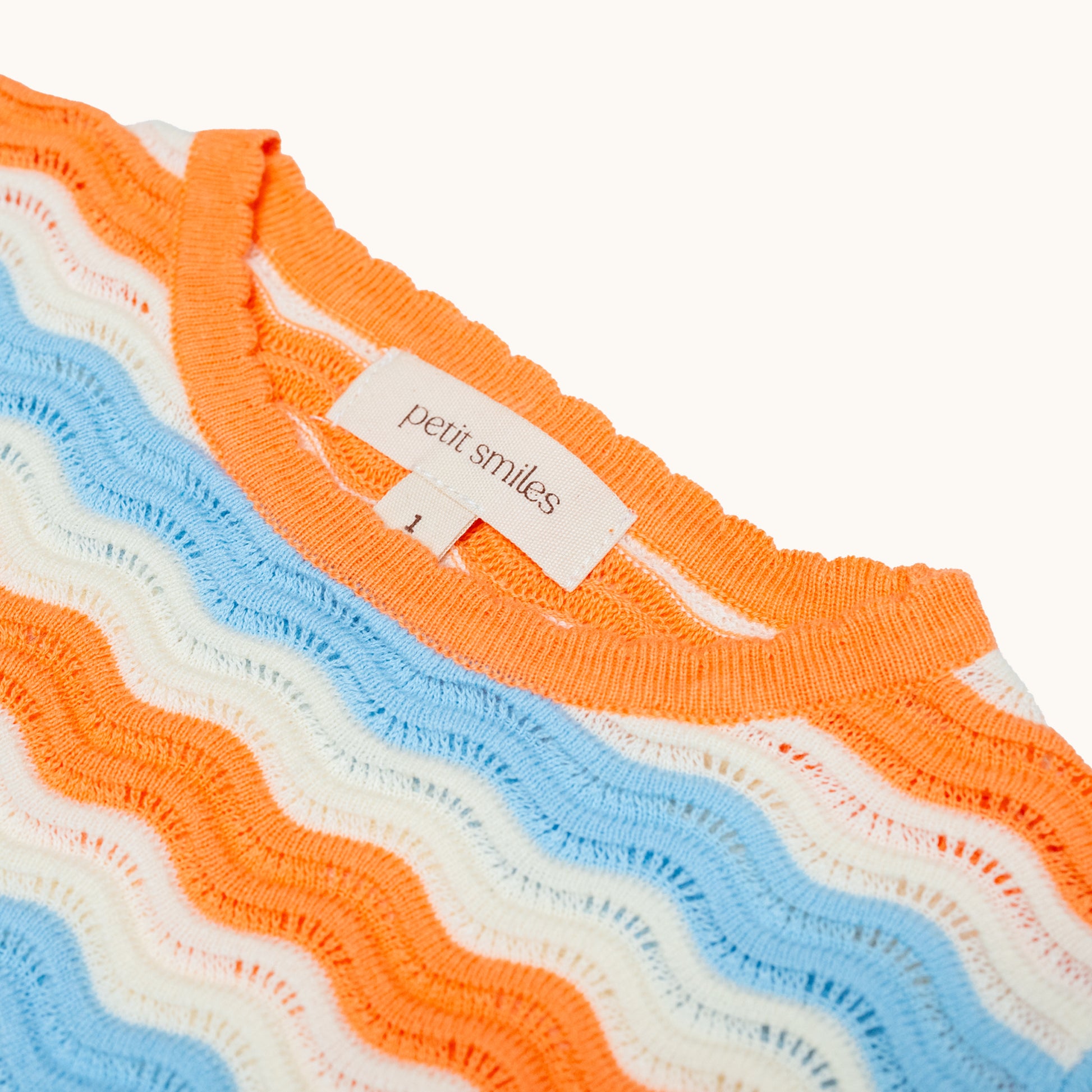 KNITTED WAVY SUMMER DRESS - CORAL; 100% Organic Cotton; Summer Dress made from GOTS-certified organic cotton; Scalloped edge at cuffs; Rib finish at hem; Dropped shoulder.