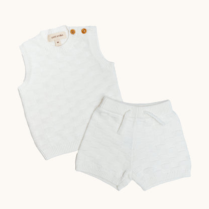 KNITTED BUTTONED WAISTCOAT - CREAM; 100% Organic Cotton; Waistcoat made from GOTS-certified organic cotton; Wooden button at shoulder for easy dressing; Rib finish at neck, hem and cuffs; Relaxed fit.