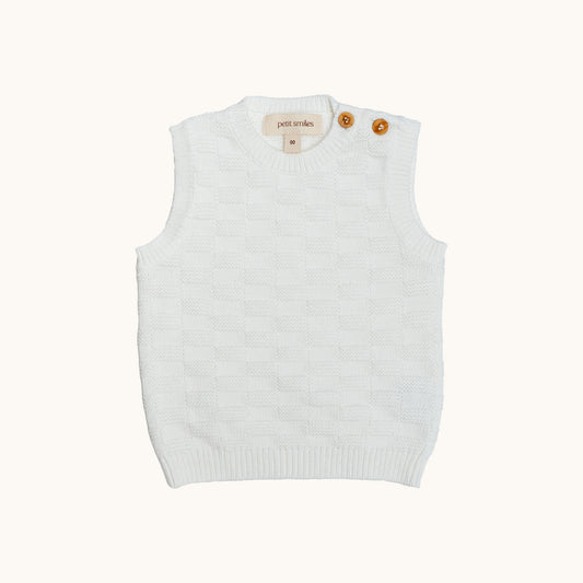 KNITTED BUTTONED WAISTCOAT - CREAM; 100% Organic Cotton; Waistcoat made from GOTS-certified organic cotton; Wooden button at shoulder for easy dressing; Rib finish at neck, hem and cuffs; Relaxed fit.