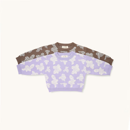 KNITTED SPOTS PULL OVER - CHOCO; 100% Organic Cotton; Jacquard Pull Over made from GOTS-certified organic cotton; 'Choco Spots' Jacquard pattern; Rib finish at neck, cuffs and hem; Dropped shoulder; Relaxed fit. 