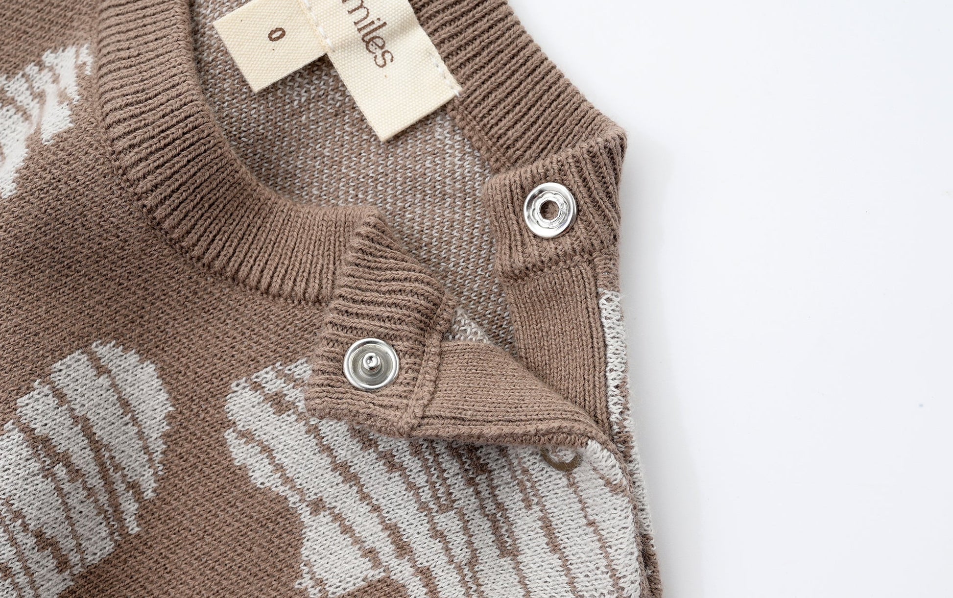 KNITTED SPOTS ROMPER WITH BLOOMERS - CHOCO; 100% Organic Cotton; Jacquard Romper made from GOTS-certified organic cotton; 'CHOCO SPOTS' Jacquard pattern; Rib hem at neck, cuffs and leg opening; Features convenient press snaps at the crotch for effortless dressing; Oversized fit.