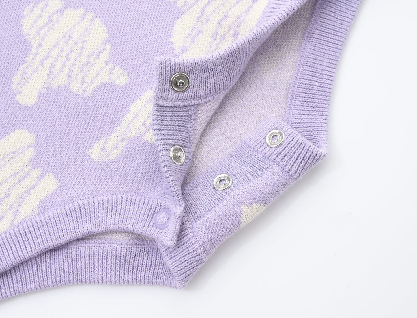 KNITTED SPOTS ROMPER - TARO; 100% Organic Cotton; Jacquard Romper made from GOTS-certified organic cotton; 'TARO SPOTS' Jacquard pattern; Rib hem at neck, cuffs and leg opening; Features convenient press snaps at the crotch for effortless dressing; Oversized fit.